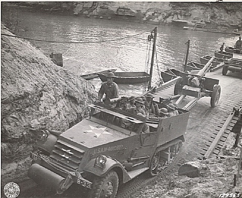 An armored car, half-track of the 78th FA passes over the bridge built by the 17th Engineers across the Sabine River