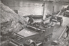 An armored car, half-track of the 78th FA passes over the bridge built by the 17th Engineers across the Sabine River