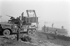 Unloading bridging equipment from a Brockway B666 6x6 bridge erector truck called Earthquake of E Company, 17thAEB