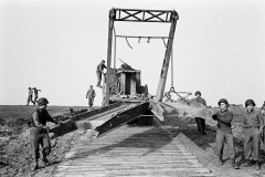 Unloading bridging equipment from a Brockway B666 6x6 bridge erector truck called Earthquake of E Company 17thAEB