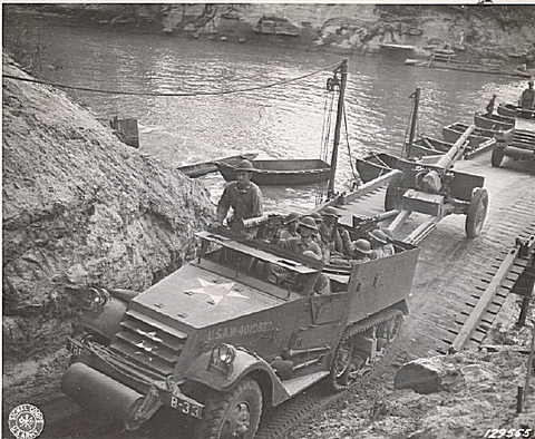 An armored car, half-track of the 78th FA passes over the bridge built by the 17th Engineers across the Sabine RiverAn armored car, half-track of the 78th FA passes over the bridge built by the 17th Engineers across the Sabine River